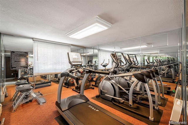 workout area featuring a textured ceiling