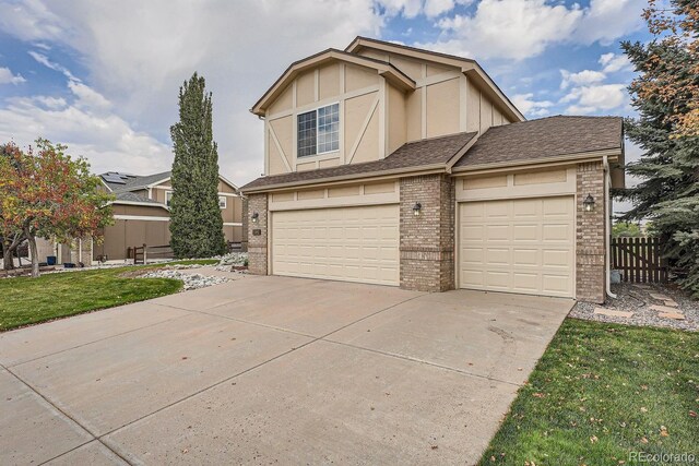 9357 Lark Sparrow Dr, Highlands Ranch, CO 80126 - view of front of property with concrete driveway, fence, brick siding, an attached garage, and a front yard