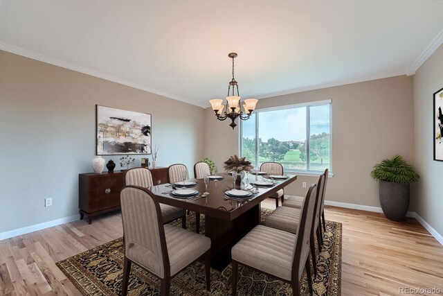 9357 Lark Sparrow Dr, Highlands Ranch, CO 80126 - dining area with a notable chandelier, baseboards, ornamental molding, and light wood-style flooring