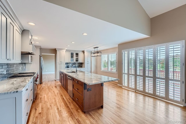 kitchen with a spacious island, hanging light fixtures, appliances with stainless steel finishes, and white cabinets