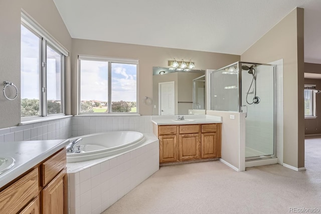 bathroom featuring vanity, shower with separate bathtub, a healthy amount of sunlight, and vaulted ceiling