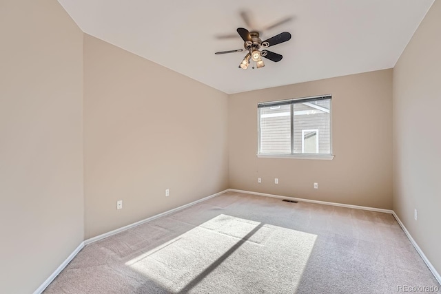 carpeted spare room with ceiling fan