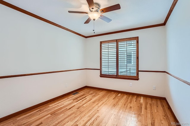 empty room with light hardwood / wood-style floors, ornamental molding, and ceiling fan