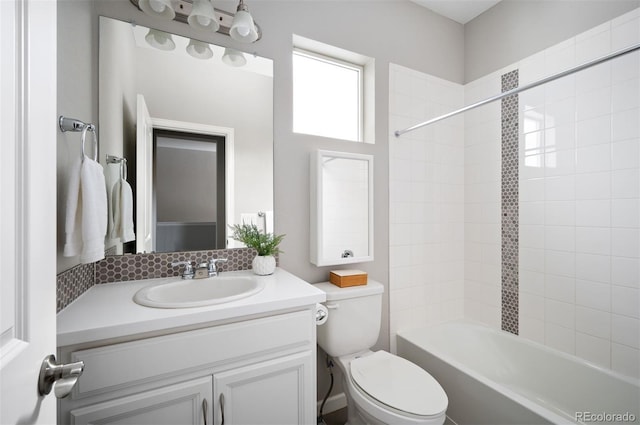 bathroom with toilet, shower / bathing tub combination, and vanity