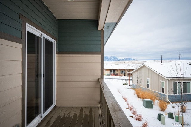 snow covered back of property with a mountain view