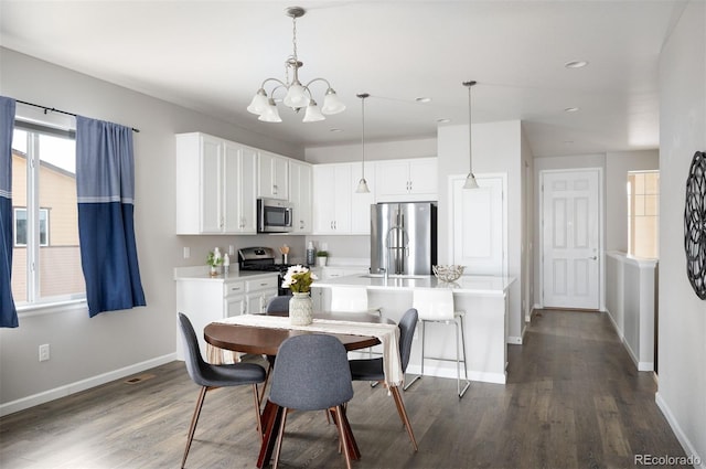 dining room with a chandelier, baseboards, dark wood finished floors, and recessed lighting