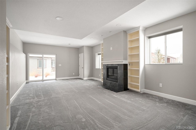 unfurnished living room with carpet floors, baseboards, and recessed lighting