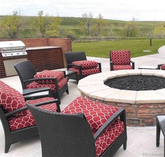 view of patio / terrace featuring grilling area and an outdoor living space with a fire pit