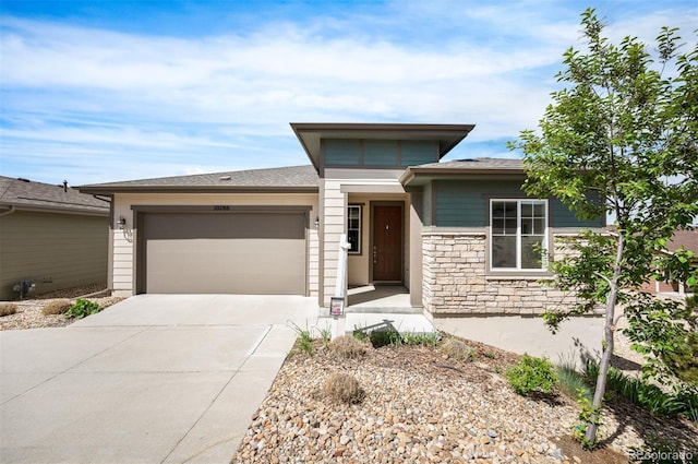 10786 Bear Cub Dr, Broomfield, CO 80021 - prairie-style home with a garage, concrete driveway, and stone siding