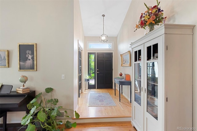 85 Willowleaf Dr, Littleton, CO 80127 - entryway with wood finished floors, high vaulted ceiling, and a chandelier