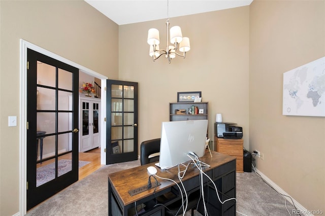 85 Willowleaf Dr, Littleton, CO 80127 - office area with carpet flooring, french doors, a chandelier, baseboards, and a high ceiling