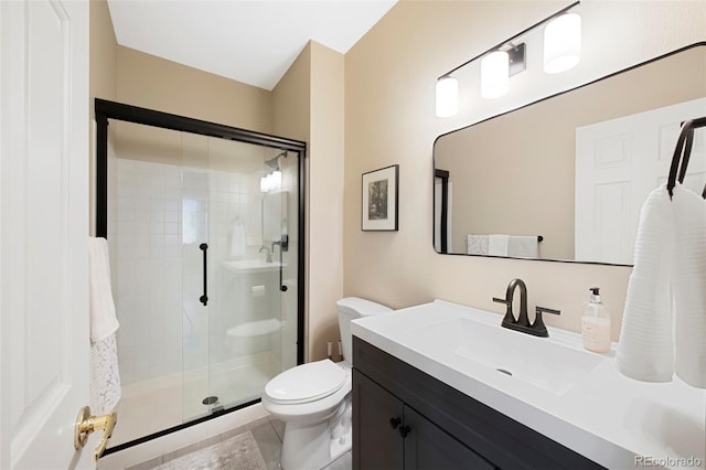 85 Willowleaf Dr, Littleton, CO 80127 - full bath with a stall shower, toilet, vanity, and tile patterned flooring