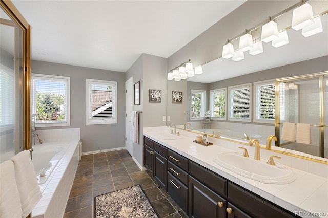 85 Willowleaf Dr, Littleton, CO 80127 - full bathroom with plenty of natural light, double vanity, a garden tub, and baseboards