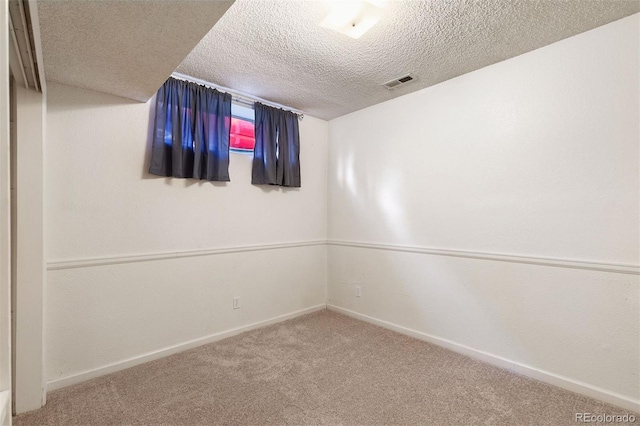 spare room with carpet floors and a textured ceiling