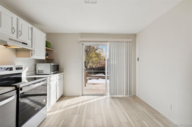 kitchen featuring white cabinets, appliances with stainless steel finishes, and light hardwood / wood-style flooring