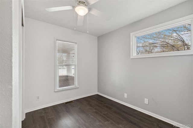 unfurnished room with ceiling fan and dark wood-type flooring