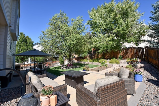 view of patio / terrace with an outdoor living space with a fire pit