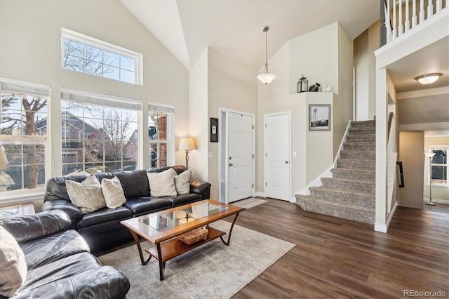 living room featuring dark hardwood / wood-style floors and high vaulted ceiling