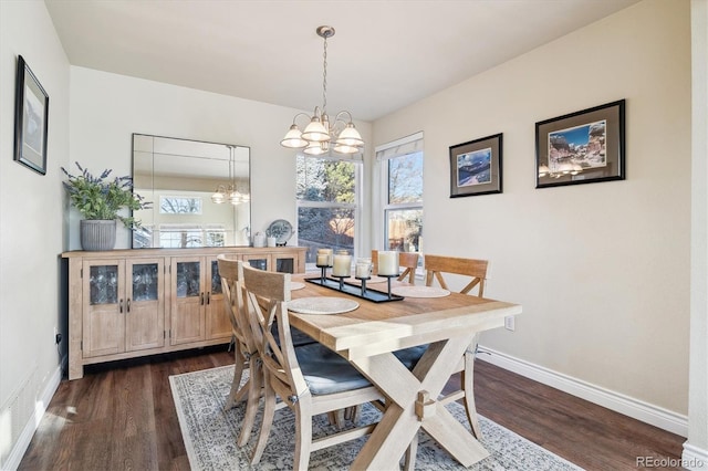 dining space featuring an inviting chandelier, a wealth of natural light, and dark hardwood / wood-style flooring