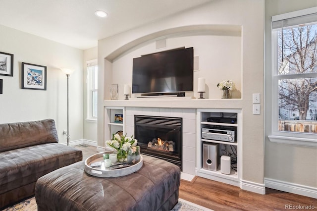 living room featuring hardwood / wood-style floors and a fireplace