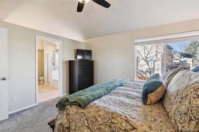 bedroom with light colored carpet, ceiling fan, and ensuite bath