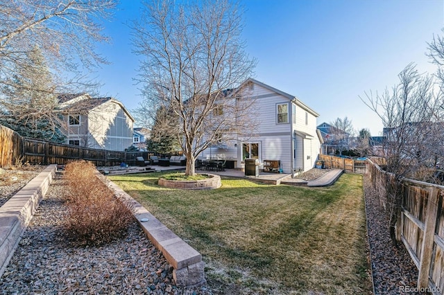 rear view of property with a yard and a patio area