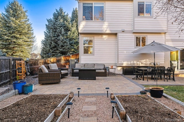 rear view of property with an outdoor living space and a patio