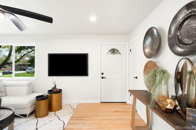 6512 Upham St, Arvada, CO 80003 - living area with wood finished floors, a ceiling fan, and baseboards