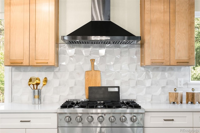 6512 Upham St, Arvada, CO 80003 - kitchen with wall chimney range hood, backsplash, stainless steel range with gas cooktop, and light countertops