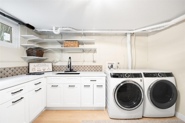 6512 Upham St, Arvada, CO 80003 - laundry room with cabinet space, independent washer and dryer, and light wood-type flooring
