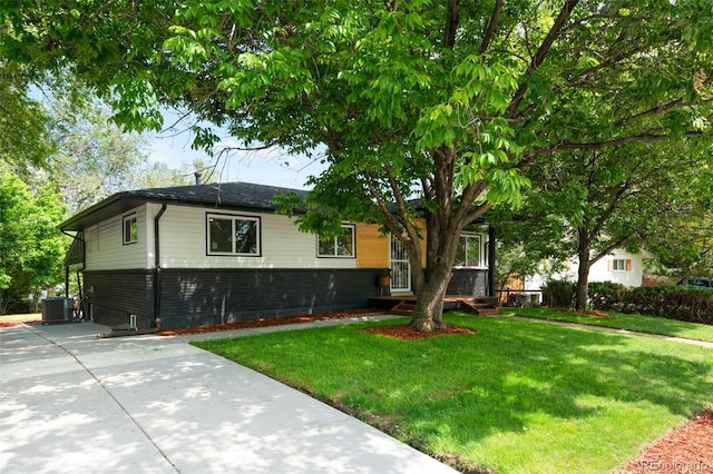6512 Upham St, Arvada, CO 80003 - ranch-style home with brick siding, central air condition unit, a front yard, and concrete driveway