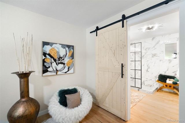 6512 Upham St, Arvada, CO 80003 - living area with a barn door and wood finished floors