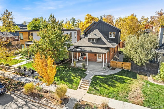 view of front of home featuring covered porch and a front lawn