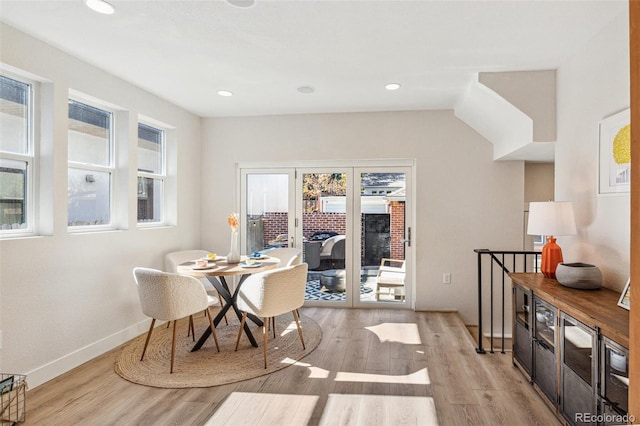 dining room featuring french doors and light hardwood / wood-style flooring