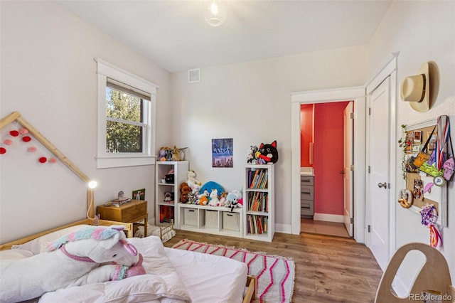 bedroom with wood-type flooring