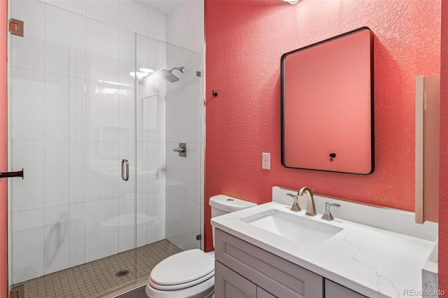 bathroom featuring vanity, an enclosed shower, and toilet