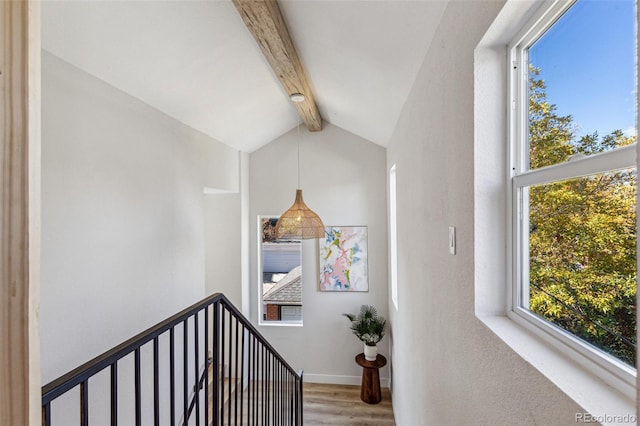 stairs featuring vaulted ceiling with beams and hardwood / wood-style flooring