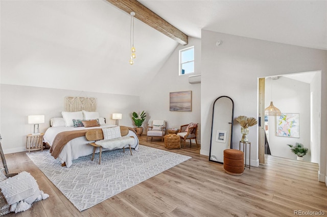 bedroom featuring beamed ceiling, an AC wall unit, high vaulted ceiling, and light hardwood / wood-style flooring