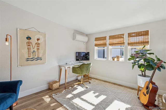 home office with hardwood / wood-style flooring and a wall mounted AC