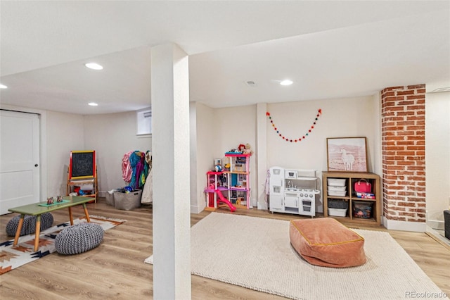 recreation room with wood-type flooring