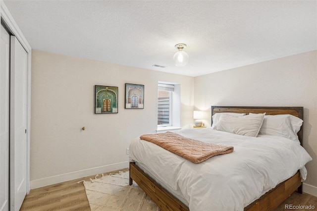 bedroom featuring a closet and light wood-type flooring