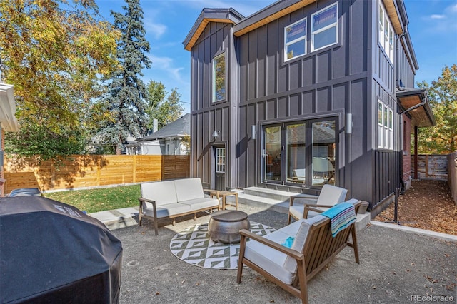 back of house featuring an outdoor living space and a patio area