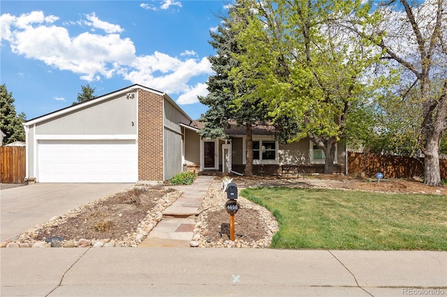 view of front of home with fence, concrete driveway, a front yard, and a garage