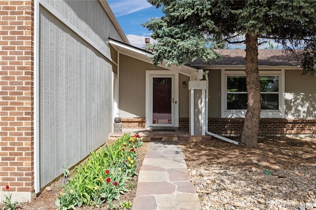 property entrance featuring brick siding