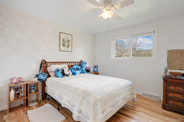 bedroom with visible vents, ceiling fan, and wood finished floors