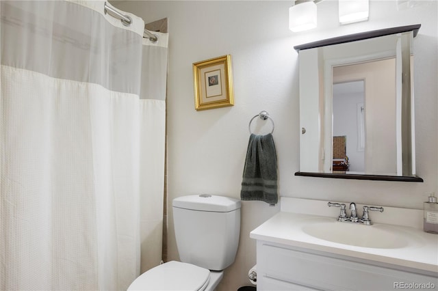 bathroom with vanity, toilet, and curtained shower