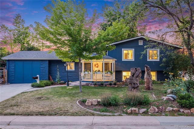 7767 S Depew St, Littleton, CO 80128 - tri-level home featuring a yard and board and batten siding