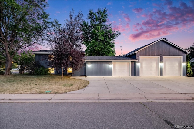 7767 S Depew St, Littleton, CO 80128 - view of front of property featuring driveway, a lawn, and a garage