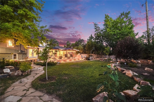 7767 S Depew St, Littleton, CO 80128 - yard at dusk with french doors and a patio area