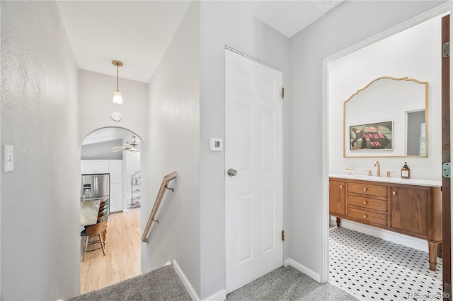 7767 S Depew St, Littleton, CO 80128 - corridor featuring a sink and an upstairs landing